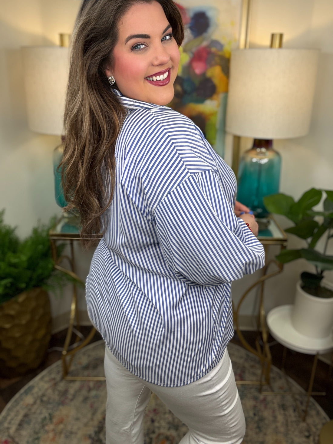 Woman wearing a blue striped button down top